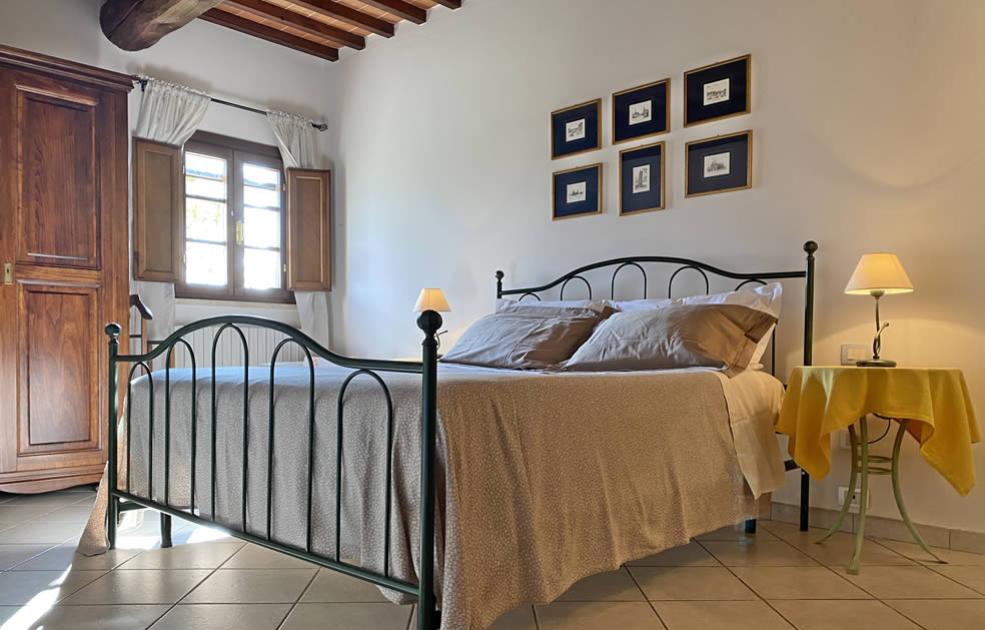 Chambre confortable avec lit en fer forgé et décoration classique.